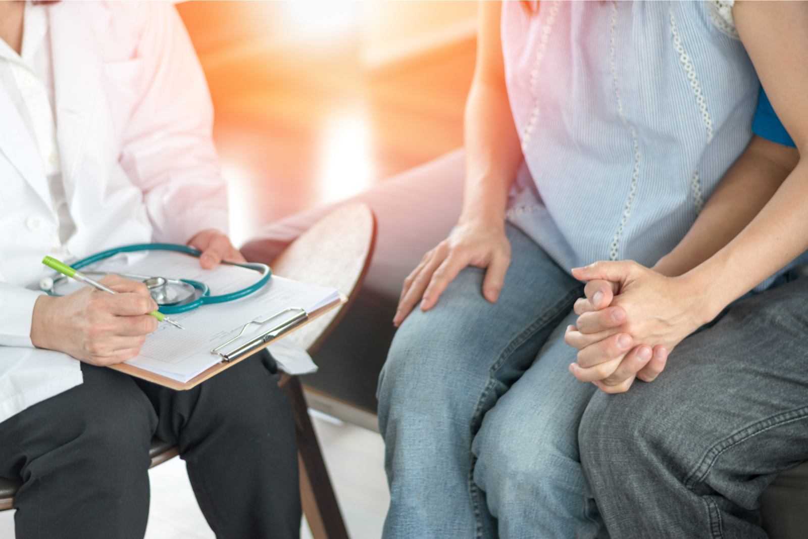 A doctor speaking with patients at their first appointment.